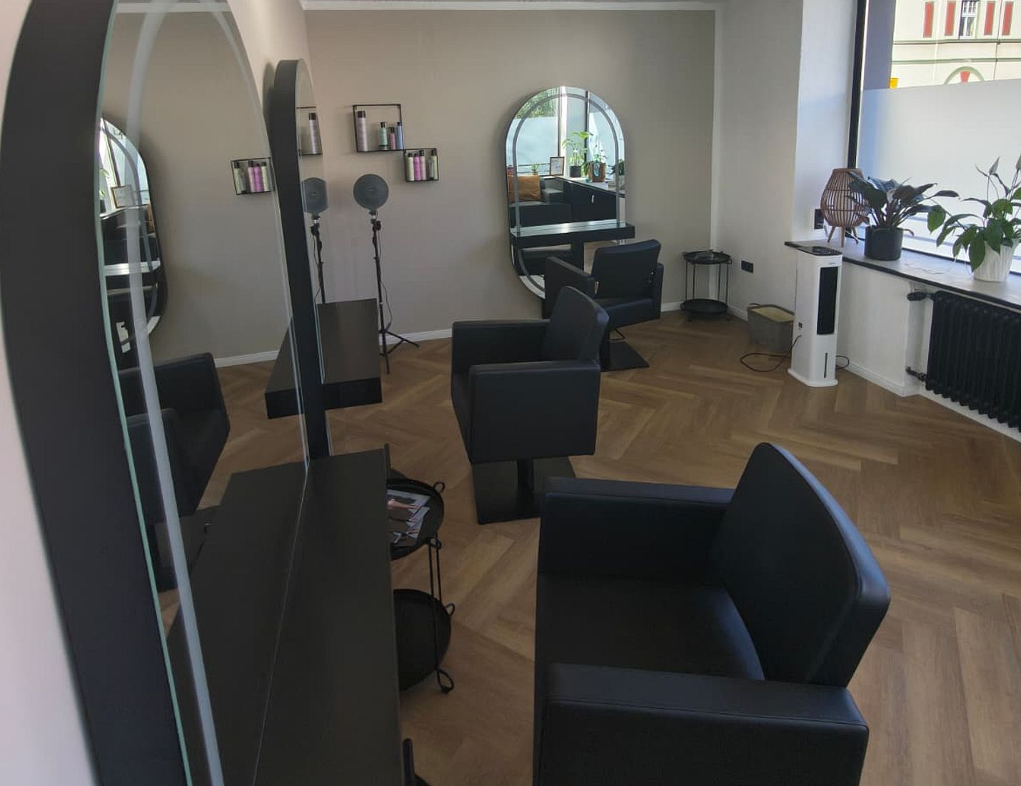 Helle Stylingplätze mit Spiegeln und Holzboden im Salon
